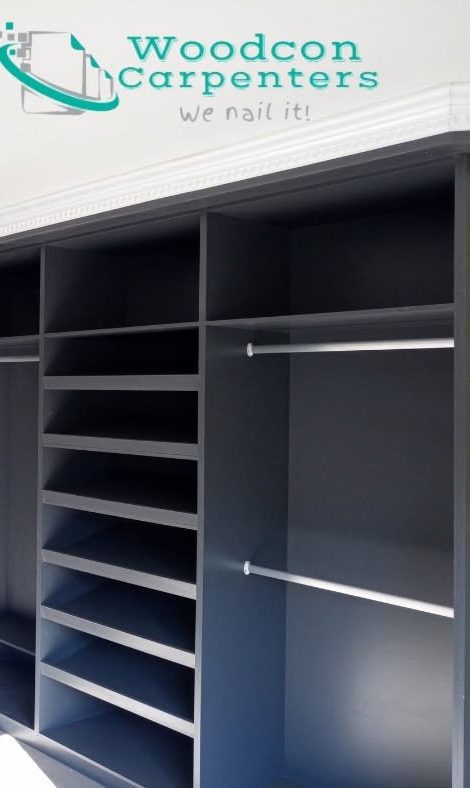 Custom walk-in wardrobe interior with hanging rails, adjustable shelves and a shoe rack